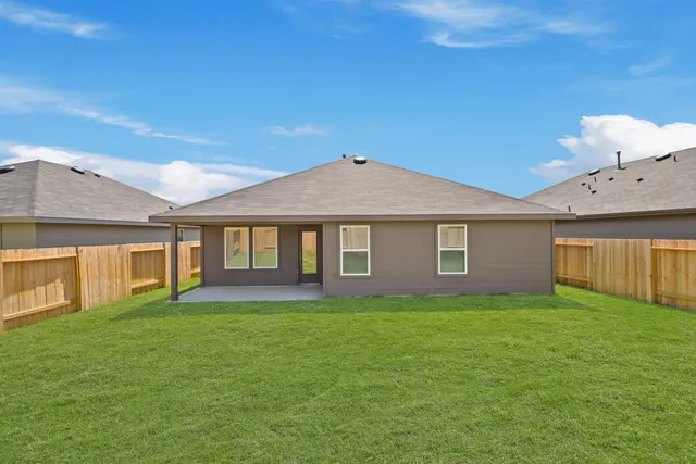 a swimming pool with outdoor seating and yard