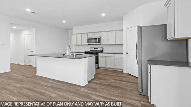 a kitchen with stainless steel appliances a refrigerator sink and cabinets