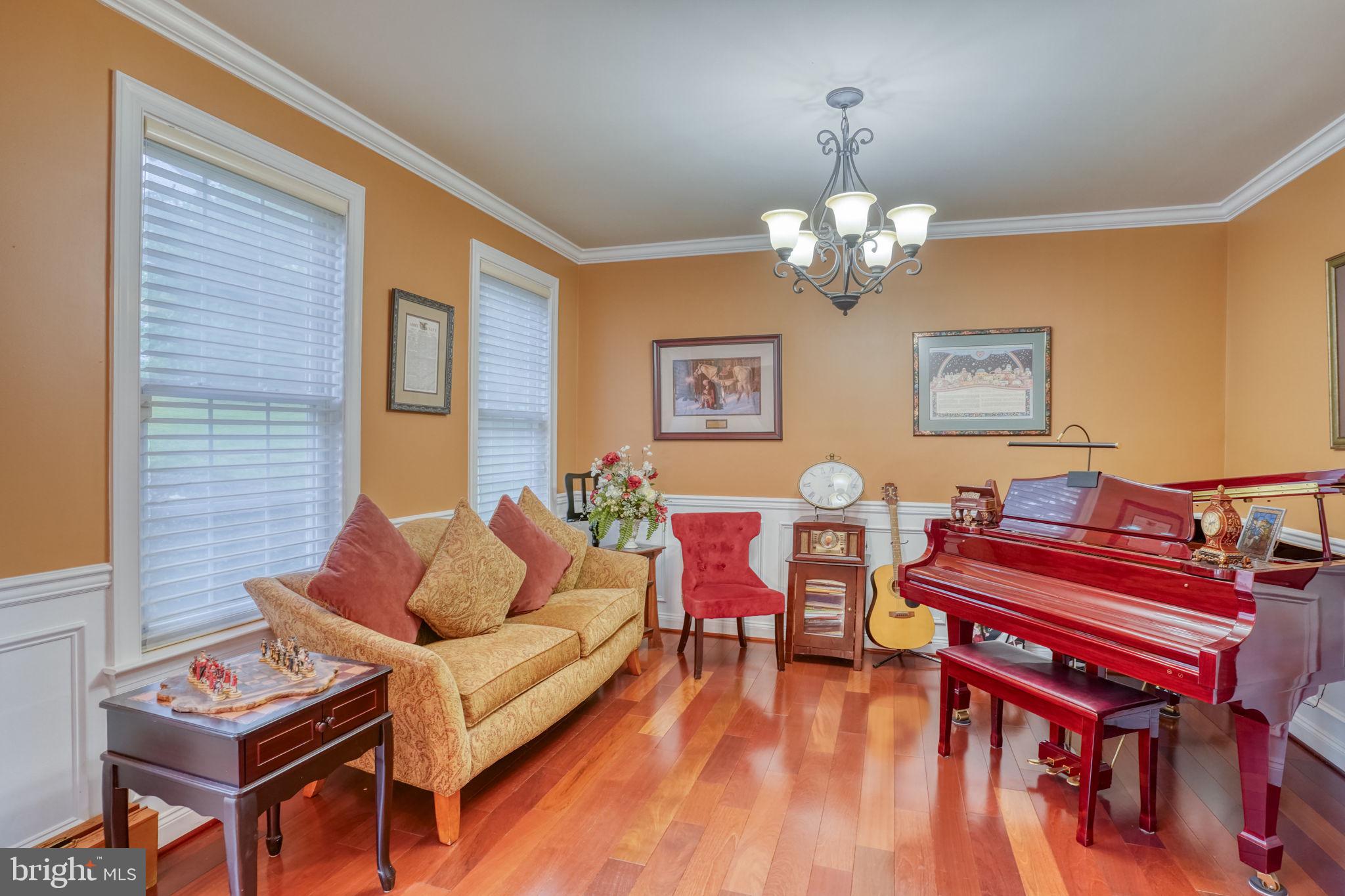 357 Willits Way Garnet Valley, PA 19060 - Photo 7 of 63 a living room with furniture a dining table and a piano next to a window