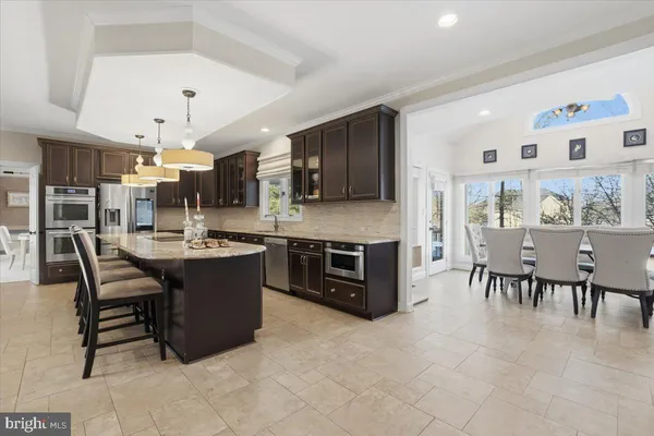 a living room with furniture a flat screen tv and a large window