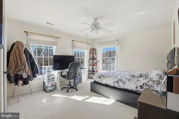 a bathroom with a sink a toilet and a large mirror