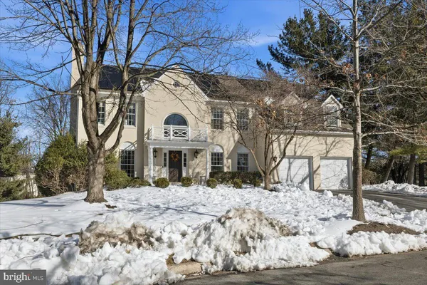 a living room with furniture large window and wooden floor