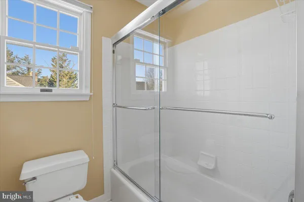 a living room with furniture a table and a potted plant