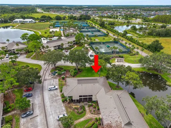 an aerial view of residential houses with outdoor space and river