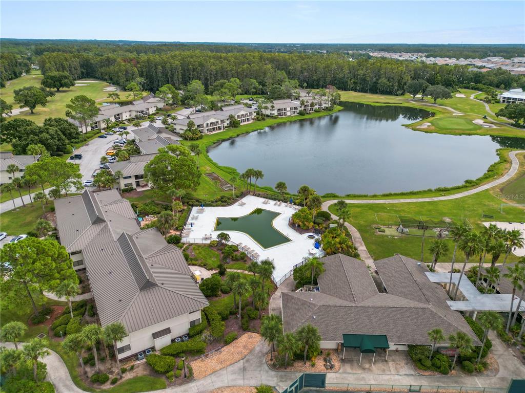 4947 Mill Pond Road, Unit 3103 & 3105 Wesley Chapel, FL 33543 - Photo 12 of 46 an aerial view of residential houses with outdoor space and lake view