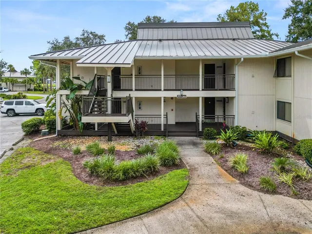 a view of a house with sitting area and garden