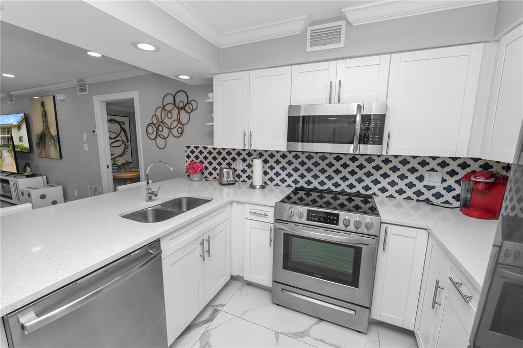 4947 Mill Pond Road, Unit 3103 & 3105 Wesley Chapel, FL 33543 - Photo 30 of 46 a kitchen with a stove and a sink