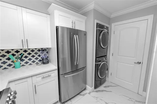 a kitchen with stainless steel appliances granite countertop a refrigerator and a stove