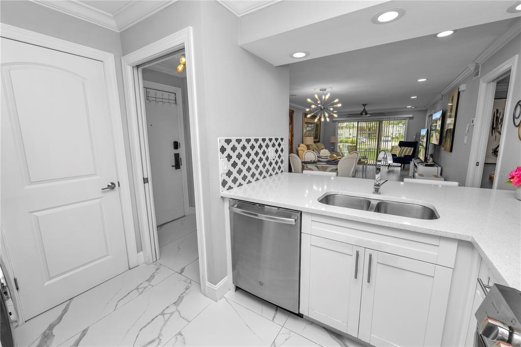 4947 Mill Pond Road, Unit 3103 & 3105 Wesley Chapel, FL 33543 - Photo 32 of 46 a kitchen with a sink and cabinets