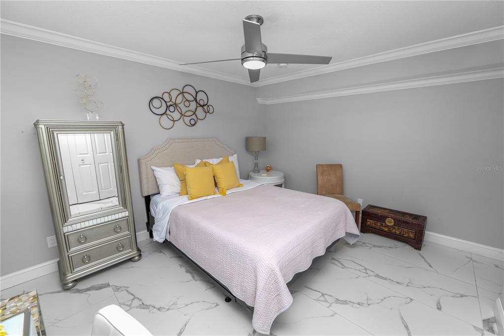 4947 Mill Pond Road, Unit 3103 & 3105 Wesley Chapel, FL 33543 - Photo 34 of 46 a bedroom with a bed and painting on the wall