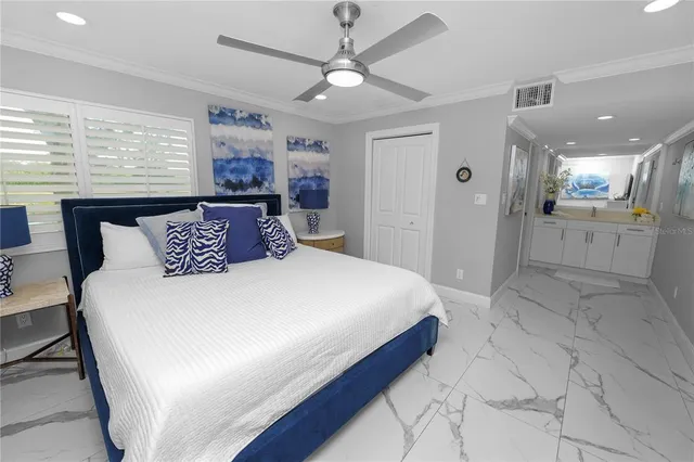 a bedroom with a large bed and a chandelier