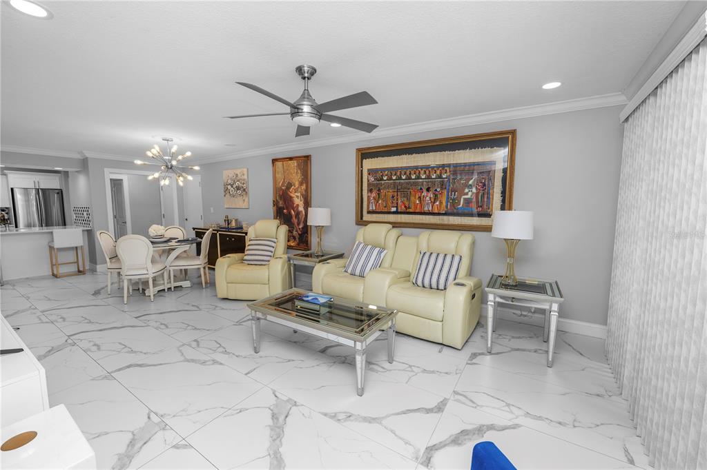 4947 Mill Pond Road, Unit 3103 & 3105 Wesley Chapel, FL 33543 - Photo 40 of 46 a living room with furniture and a chandelier