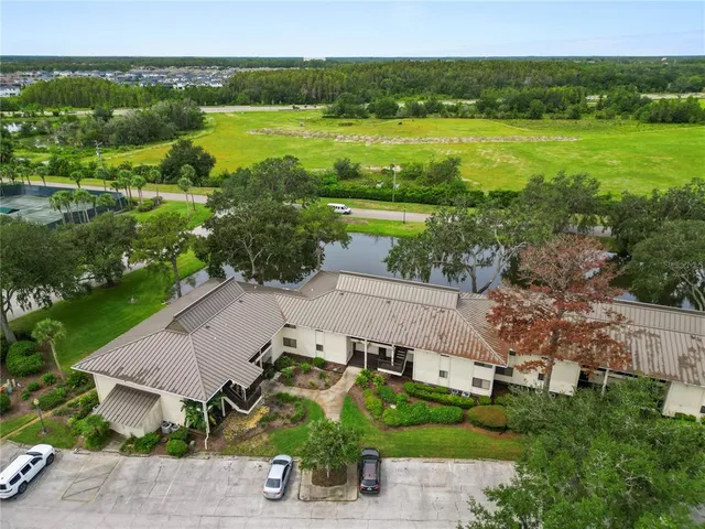 an aerial view of a house with a yard