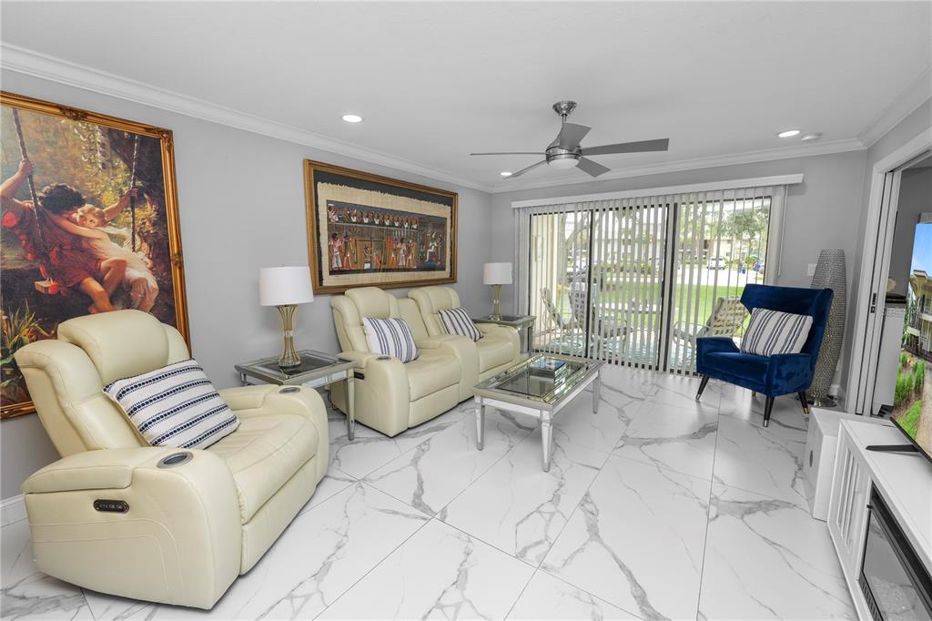 4947 Mill Pond Road, Unit 3103 & 3105 Wesley Chapel, FL 33543 - Photo 41 of 46 a living room with furniture and a large window