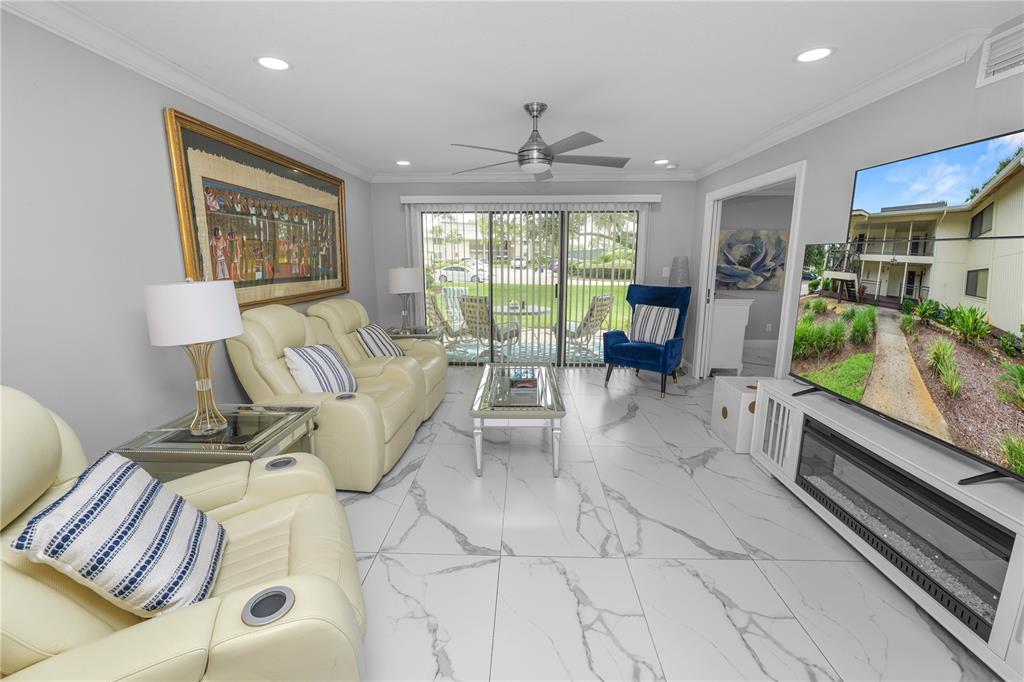 4947 Mill Pond Road, Unit 3103 & 3105 Wesley Chapel, FL 33543 - Photo 43 of 46 a living room with furniture and a large window