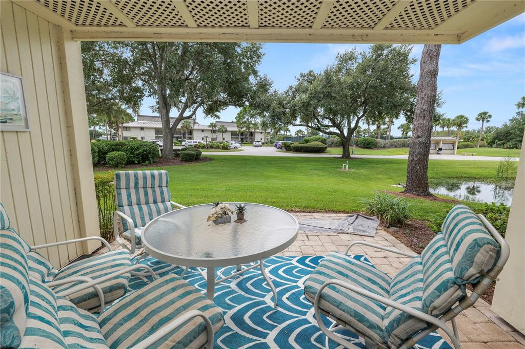 4947 Mill Pond Road, Unit 3103 & 3105 Wesley Chapel, FL 33543 - Photo 5 of 46 a view of a patio with a table chairs and a table