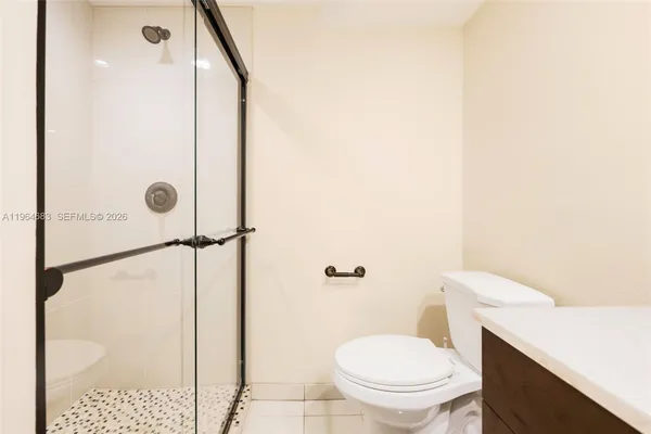 a bathroom with a toilet and a shower