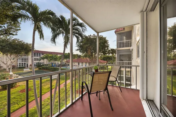 a view of a chairs and table in patio with a glass door