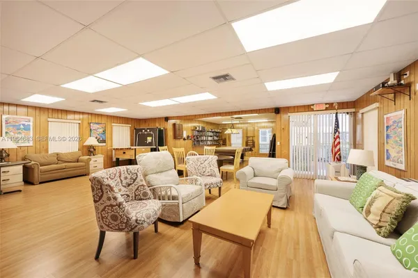 a living room with furniture a wooden floor and gym equipment