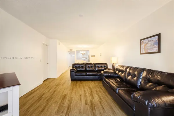 a living room with a couch and a wooden floor