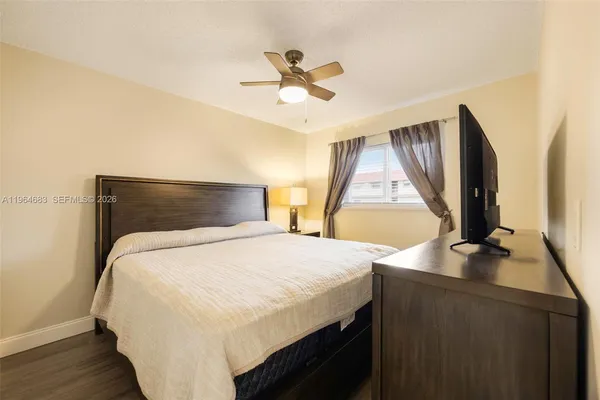 a bedroom with a bed and a ceiling fan