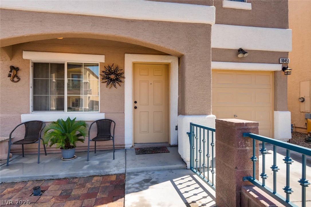 10451 Processor Court Las Vegas, NV 89129 - Photo 3 of 28 A well-maintained facade with a private entryway and an integrated garage offers immediate curb appeal.