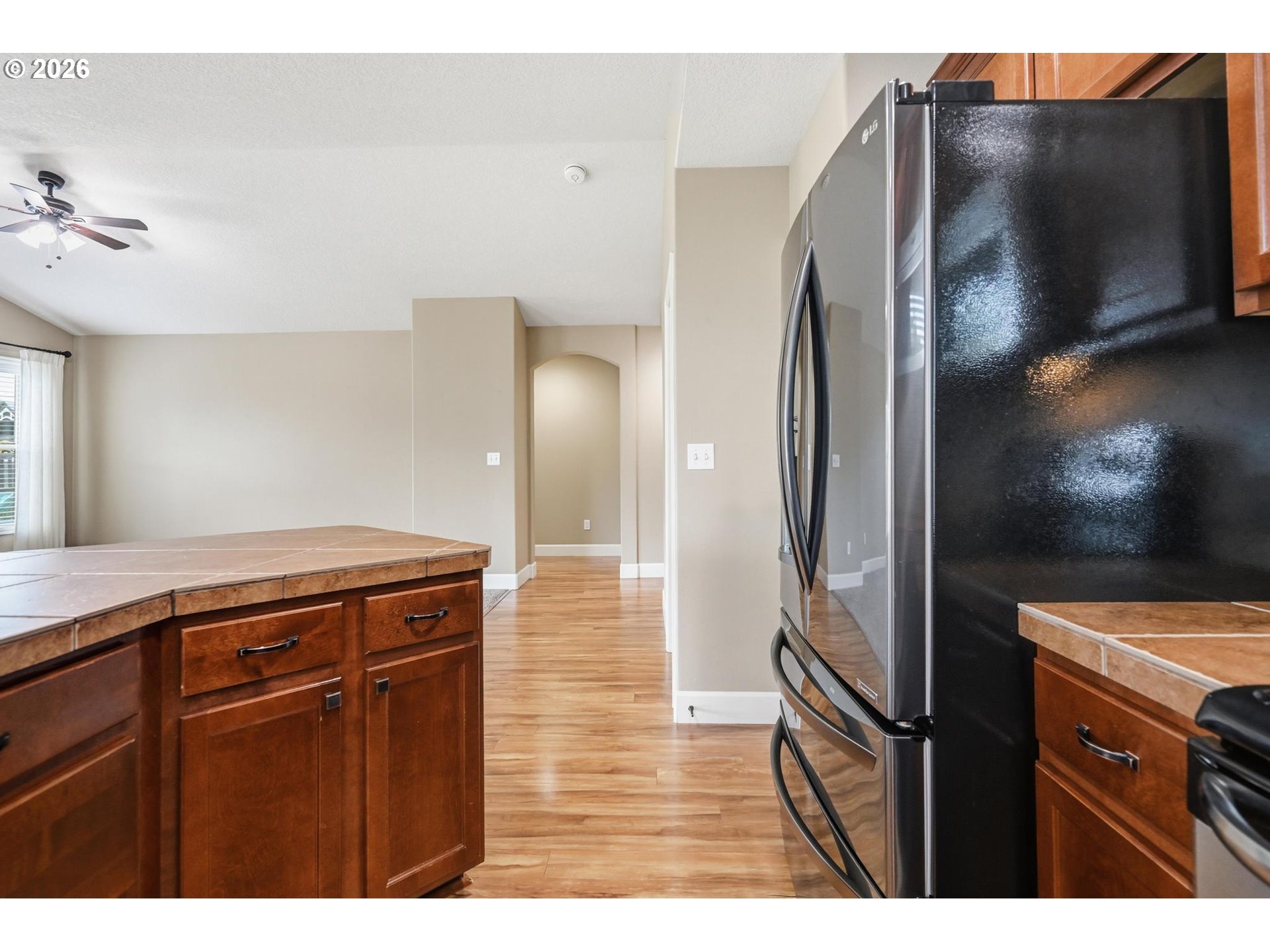 1075 Sage Street Silverton, OR 97381 - Photo 32 of 46 a kitchen with stainless steel appliances a refrigerator and a wooden floor