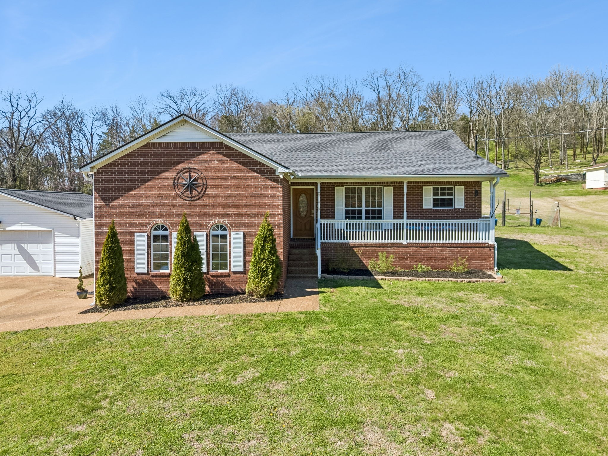 1245 Cliff Amos Road Spring Hill, TN 37174 - Photo 38 of 41 a front view of house with yard and trees in the background