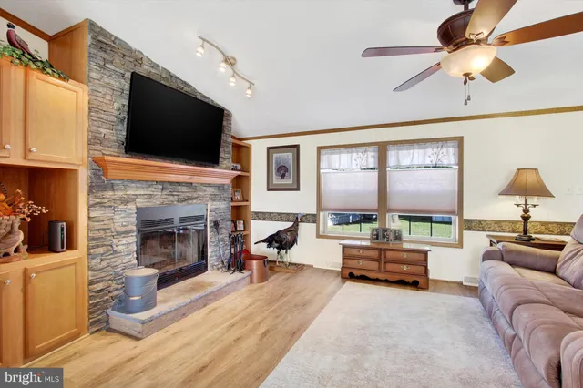 a living room with fireplace furniture and a flat screen tv