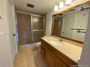 4166 Inverrary Drive, Unit 303 Lauderhill, FL 33319 - Photo 4 of 12 a bathroom with a sink and a mirror