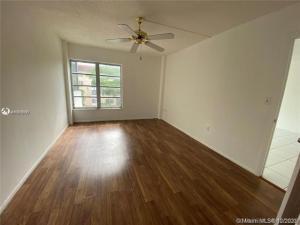 4166 Inverrary Drive, Unit 303 Lauderhill, FL 33319 - Photo 5 of 12 wooden floor in an empty room with a window
