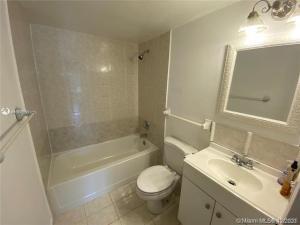 4166 Inverrary Drive, Unit 303 Lauderhill, FL 33319 - Photo 7 of 12 a bathroom with a sink toilet and shower