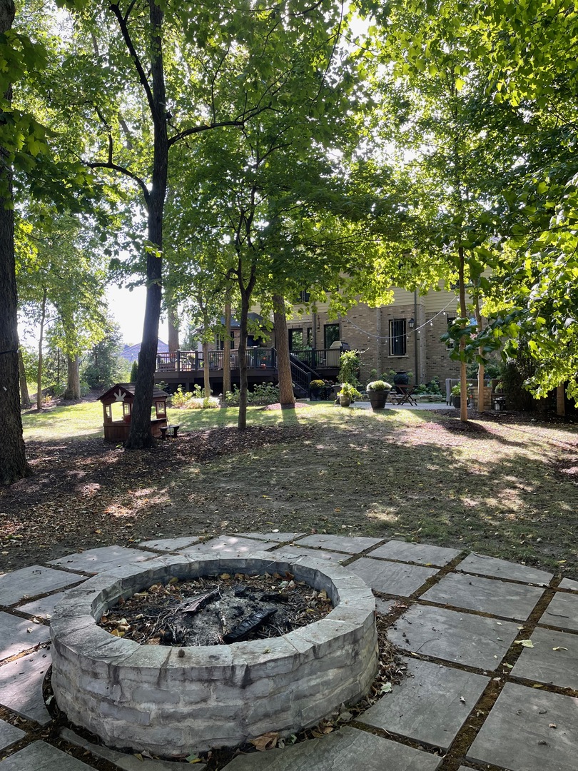Undisclosed Address Frankfort, IL 60423 - Photo 6 of 9 a view of a backyard with water fountain and large trees
