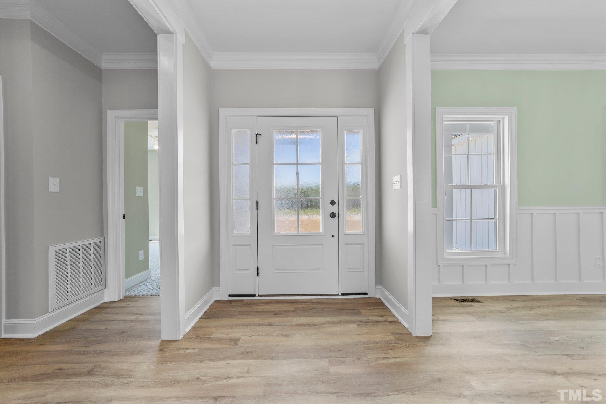 5748 Harvest Rdg Road Battleboro, NC 27809 - Photo 20 of 44 an empty room with wooden floor and windows