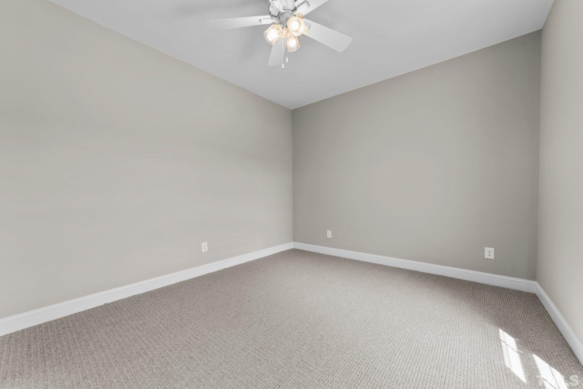 5748 Harvest Rdg Road Battleboro, NC 27809 - Photo 29 of 44 an empty room with a ceiling fan and a window