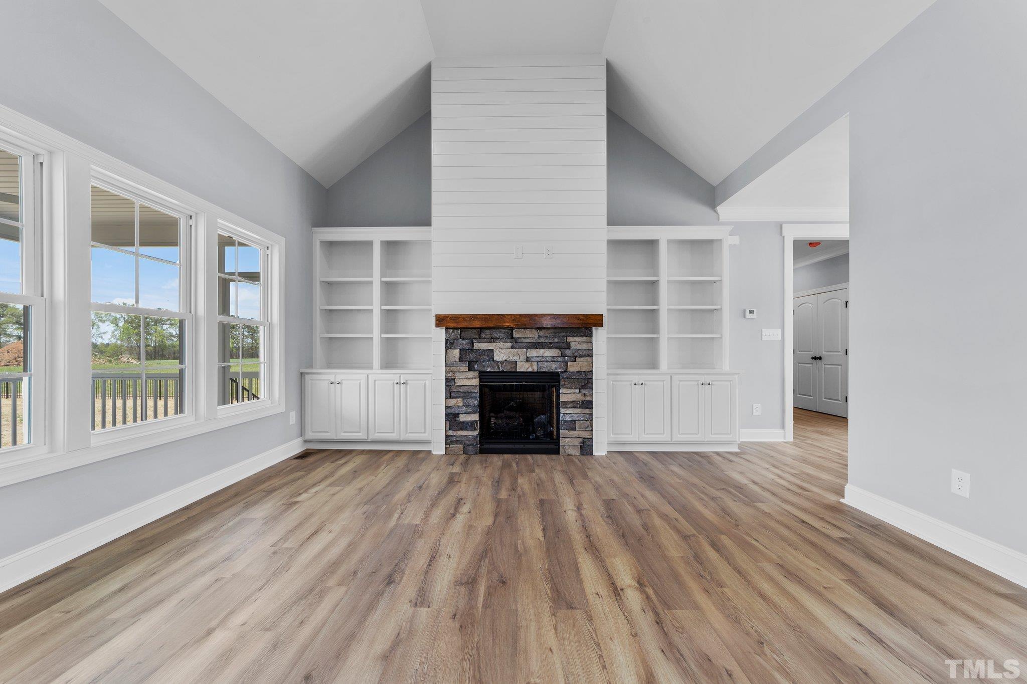 5748 Harvest Rdg Road Battleboro, NC 27809 - Photo 31 of 44 wooden floor fireplace and windows in an empty room
