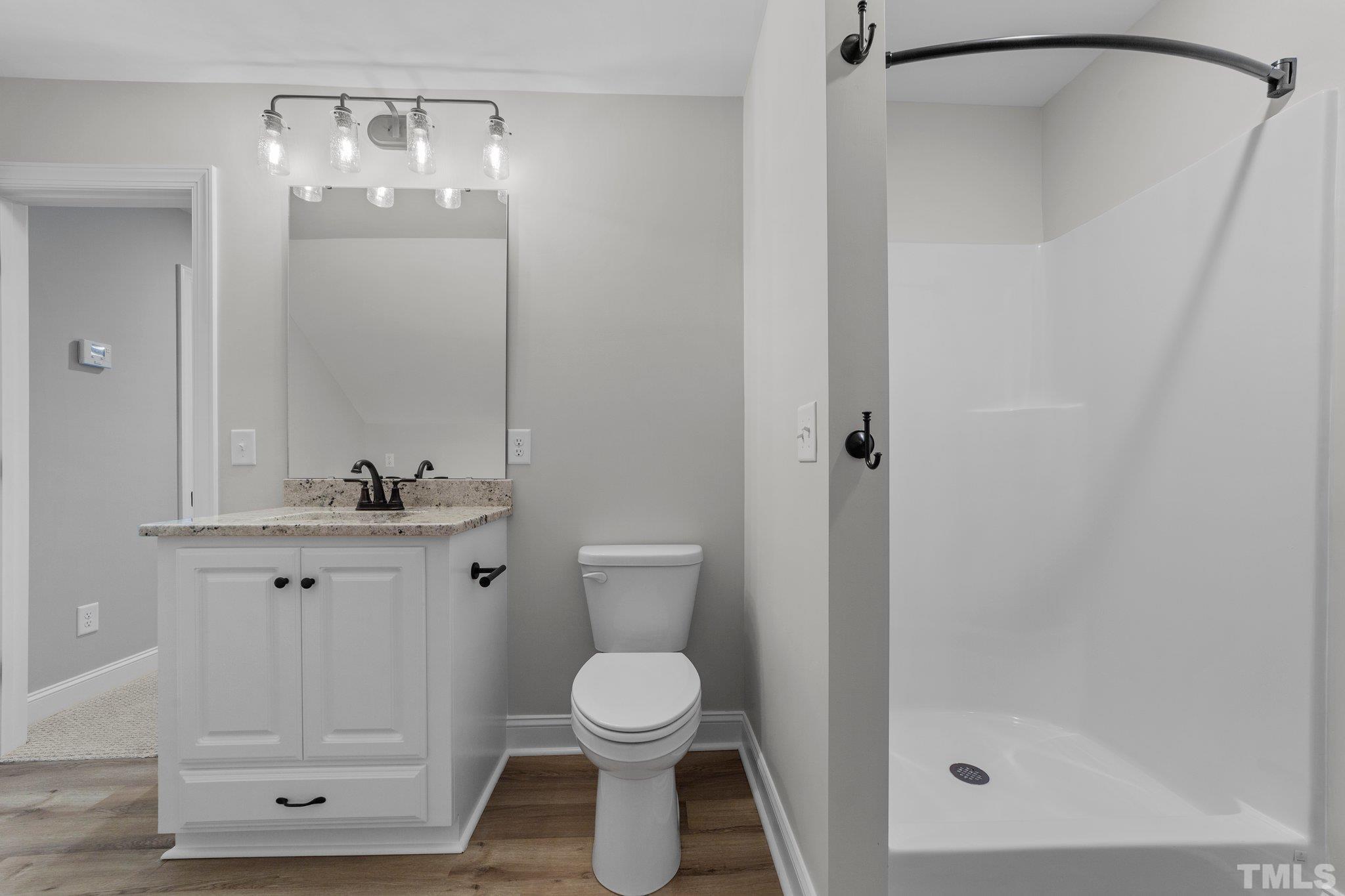 5748 Harvest Rdg Road Battleboro, NC 27809 - Photo 42 of 44 a bathroom with a granite countertop sink toilet and shower