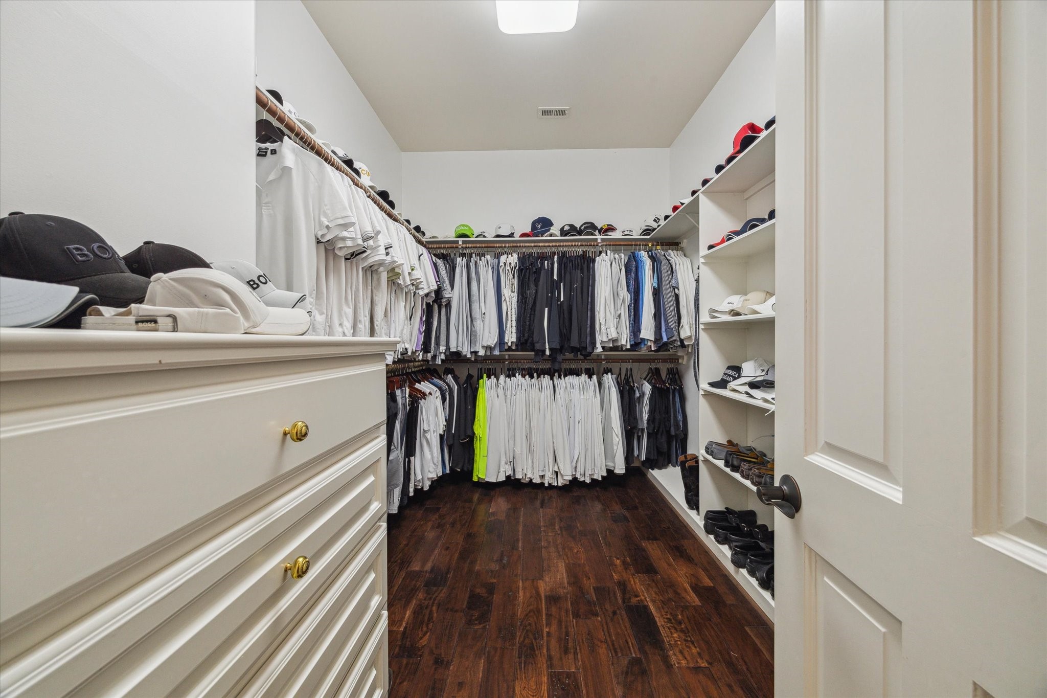 3319 Bridgeberry Lane Houston, TX 77082 - Photo 20 of 50 One of the first floor master suite closets with chest storage and wood flooring