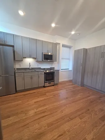 a large kitchen with cabinets and stainless steel appliances