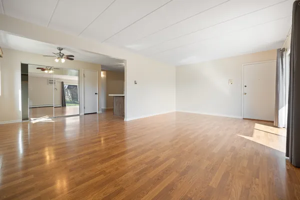 wooden floor in an empty room with a window