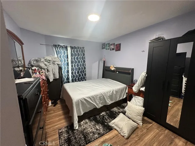 a bedroom with a bed and a television