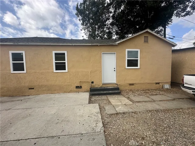 a front view of a house with parking space
