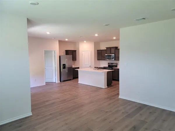 a view of kitchen with wooden floor and electronic appliances