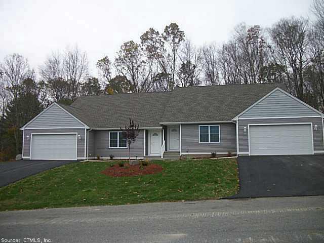 39 Providence Road, Unit 9 Brooklyn, CT 06234 - Photo 1 of 1 front view of house with a yard