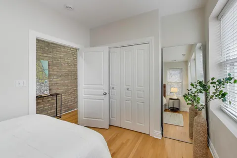 a bedroom with a bed and a potted plant