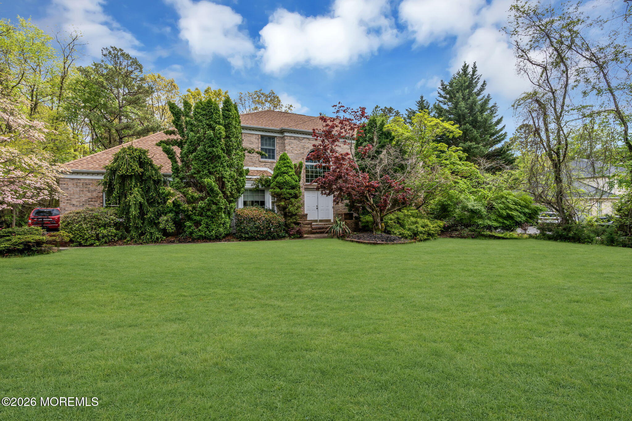 4 Quaker Hill Road Jackson, NJ 08527 - Photo 6 of 70 a view of a garden with a building in the background