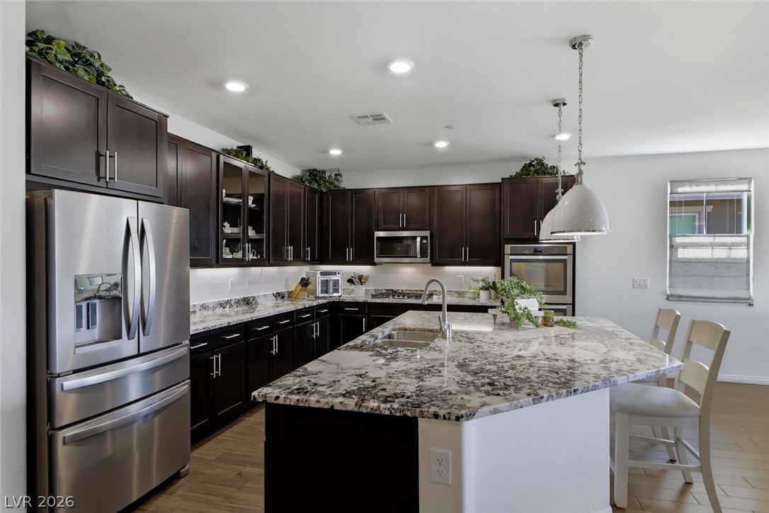 2922 Ventana Ridge Avenue Henderson, NV 89044 - Photo 21 of 57 A luxury kitchen option package was selected for this home which included this enlarged kitchen island with granite counters and a flat polished edge.