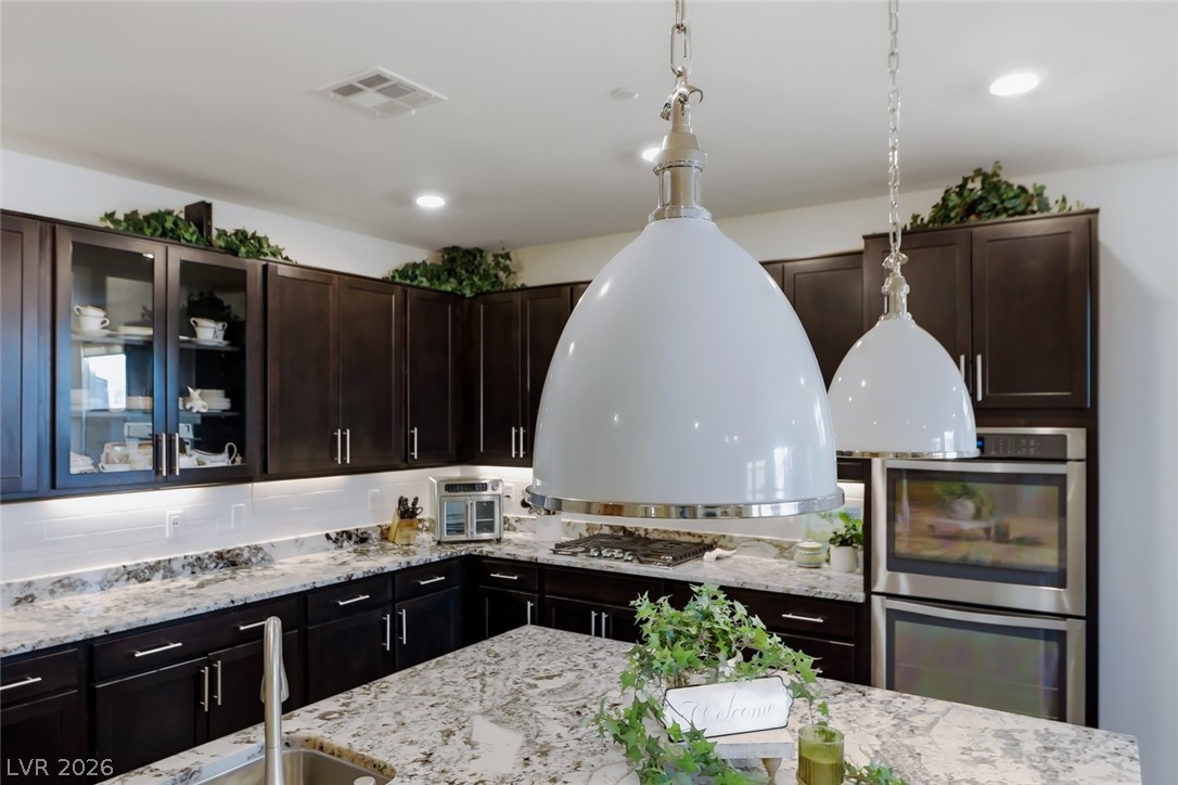 2922 Ventana Ridge Avenue Henderson, NV 89044 - Photo 22 of 57 Custom 42" upper cabinets. All cabinetry is finished in a Sasparilla color.
