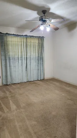 a bathroom with a granite countertop sink a toilet and a mirror