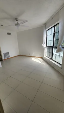 a large kitchen with a large counter top stainless steel appliances and cabinets